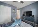 Comfortable bedroom featuring a large closet, stylish furniture, and calming blue walls at 17413 Garden Heath Ct, Land O Lakes, FL 34638