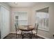 Bright dining area with wood flooring, a round table, two windows with blinds, and ample natural light at 17413 Garden Heath Ct, Land O Lakes, FL 34638