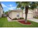 Charming single-story home showcasing landscaped front yard, palm tree, and attached garage at 17413 Garden Heath Ct, Land O Lakes, FL 34638