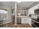 Modern kitchen featuring stainless steel appliances, granite countertops, and white cabinetry at 17413 Garden Heath Ct, Land O Lakes, FL 34638