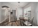 Breakfast nook with a stainless steel refrigerator and view of the hallway and backyard at 17413 Garden Heath Ct, Land O Lakes, FL 34638
