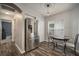 Bright breakfast nook area featuring stainless steel refrigerator, pendant lighting, and window with blinds at 17413 Garden Heath Ct, Land O Lakes, FL 34638