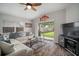 Well-lit living room offering a seamless transition to the outdoor space through a sliding glass door at 17413 Garden Heath Ct, Land O Lakes, FL 34638