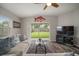 Inviting living room with a decorative fish accent, backyard access, and comfortable seating arrangements at 17413 Garden Heath Ct, Land O Lakes, FL 34638