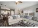 Bright living area with a large sectional sofa and a view of the open-concept dining area and kitchen at 17413 Garden Heath Ct, Land O Lakes, FL 34638