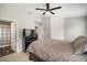 Spacious bedroom with a queen bed, closet access, and an open doorway view to the kitchen at 17413 Garden Heath Ct, Land O Lakes, FL 34638