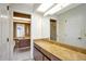 Bright bathroom with marble counters, a large mirror, tiled floors, and plenty of vanity space at 18807 Tournament Trl, Tampa, FL 33647