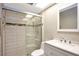 Modern bathroom featuring a shower with glass door, a sink with vanity, and decorative mosaic tile accents at 18807 Tournament Trl, Tampa, FL 33647
