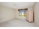 Bright bedroom with neutral tones, ceiling fan, window with blinds, and wardrobe for ample storage at 18807 Tournament Trl, Tampa, FL 33647