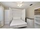 Bright bedroom with a built-in Murphy bed and storage, perfect for maximizing space and functionality at 18807 Tournament Trl, Tampa, FL 33647
