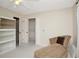 Well-lit bedroom featuring a chaise lounge, built-in shelves, and a walk-in closet for ample storage at 18807 Tournament Trl, Tampa, FL 33647