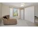 Comfortable bedroom with ample sunlight, a chaise lounge, and built-in wardrobe cabinets at 18807 Tournament Trl, Tampa, FL 33647
