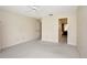Spacious bedroom with neutral carpeting featuring an ensuite bathroom, offering convenience and privacy at 18807 Tournament Trl, Tampa, FL 33647