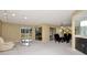 Spacious living and dining area with light carpet, wet bar, and sliding glass doors to the outside at 18807 Tournament Trl, Tampa, FL 33647