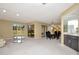 Bright and airy living space featuring neutral walls, carpet, and sliding glass doors that lead to outdoor space at 18807 Tournament Trl, Tampa, FL 33647