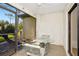 Relaxing screened patio with a table, chairs, and beautiful views of the outdoors at 18807 Tournament Trl, Tampa, FL 33647