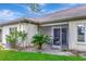 Backyard patio with screen, showing furniture, and yard at 18807 Tournament Trl, Tampa, FL 33647
