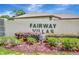 Community signage that reads, 'Fairway Villas' amongst well-maintained shrubbery at 18807 Tournament Trl, Tampa, FL 33647