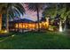 Backyard featuring a pool and screened enclosure, with landscaping and outdoor lighting at 1915 Floresta View Dr, Tampa, FL 33618