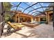 Relaxing backyard featuring a screened-in pool, hot tub, tiled deck, and comfortable lounge chairs at 1915 Floresta View Dr, Tampa, FL 33618