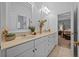 Bright bathroom featuring a double vanity with neutral countertops, mirrors, and a view into the bedroom at 1915 Floresta View Dr, Tampa, FL 33618