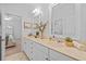 Bright bathroom featuring a double vanity with neutral countertops, mirrors, and a view into the bedroom at 1915 Floresta View Dr, Tampa, FL 33618