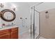 Elegant bathroom features a vanity with granite countertops, framed mirror, and glass enclosed shower at 1915 Floresta View Dr, Tampa, FL 33618