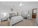 Bright bedroom with white walls, plush carpet, a ceiling fan, and a mirrored vanity at 1915 Floresta View Dr, Tampa, FL 33618