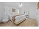 Inviting bedroom with plush carpeting, a ceiling fan, bright windows, and a decorative mirror at 1915 Floresta View Dr, Tampa, FL 33618