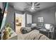 Stylish bonus room with a sectional sofa, adjacent to kitchen through an open doorway at 1915 Floresta View Dr, Tampa, FL 33618
