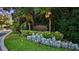 Landscaped entrance to New Floresta, featuring a decorative community sign at 1915 Floresta View Dr, Tampa, FL 33618