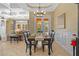 Open dining room showcasing coffered ceiling, classic chandelier, and views of the living room and backyard at 1915 Floresta View Dr, Tampa, FL 33618