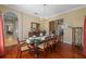 Beautiful dining room with hardwood floors and a glass-top table provides an elegant space for meals at 1915 Floresta View Dr, Tampa, FL 33618