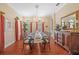 Elegant dining room with hardwood floors, a glass-top table, and decorative lighting at 1915 Floresta View Dr, Tampa, FL 33618