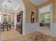 Elegant dining room featuring a decorative chandelier, a large dark wood hutch, and wainscoting at 1915 Floresta View Dr, Tampa, FL 33618