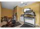 Exercise room complete with treadmill, elliptical, Peloton bicycle, and tv at 1915 Floresta View Dr, Tampa, FL 33618