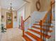 Bright foyer boasts a wood staircase, tiled floors, and a clear view through the front door at 1915 Floresta View Dr, Tampa, FL 33618
