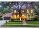 Two-story home with red tile roof, arched entryway, and warm lighting at 1915 Floresta View Dr, Tampa, FL 33618