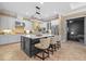 Gourmet kitchen boasts large island with seating, pendant lights, stone countertops and stainless steel appliances at 1915 Floresta View Dr, Tampa, FL 33618