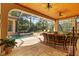 This screened-in lanai showcases a pool, spa, and comfortable seating, creating a relaxing outdoor living space at 1915 Floresta View Dr, Tampa, FL 33618