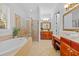 Bright main bathroom boasting a soaking tub, walk-in shower, double vanity, and a makeup vanity at 1915 Floresta View Dr, Tampa, FL 33618