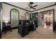 Elegantly furnished home office with dark trim and arched windows offers an inspiring workspace at 1915 Floresta View Dr, Tampa, FL 33618