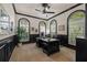 Sophisticated home office featuring dark wood trim, arched windows, and a stylish ceiling fan at 1915 Floresta View Dr, Tampa, FL 33618