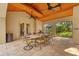 Inviting covered outdoor dining area featuring a stone table and seating for eight under a beautiful wood ceiling at 1915 Floresta View Dr, Tampa, FL 33618