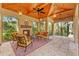 The outdoor seating area features a fireplace, tiled flooring, and screened walls for enjoying the weather at 1915 Floresta View Dr, Tampa, FL 33618