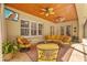 Comfortable outdoor seating on a screened lanai with a view of the pool and lush greenery at 1915 Floresta View Dr, Tampa, FL 33618