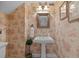 Charming powder room features toile wallpaper, pedestal sink, decorative sconces, and framed mirror at 1915 Floresta View Dr, Tampa, FL 33618