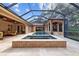 An incredible screened-in swimming pool and jacuzzi surrounded by a beautiful backyard at 1915 Floresta View Dr, Tampa, FL 33618