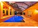 Inviting swimming pool with a hot tub, screened enclosure, and overhead lighting at 1915 Floresta View Dr, Tampa, FL 33618
