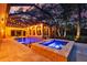 Swimming pool and hot tub in a screened enclosure with poolside lighting at 1915 Floresta View Dr, Tampa, FL 33618
